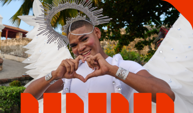 A person making a heart symbol with their hands.